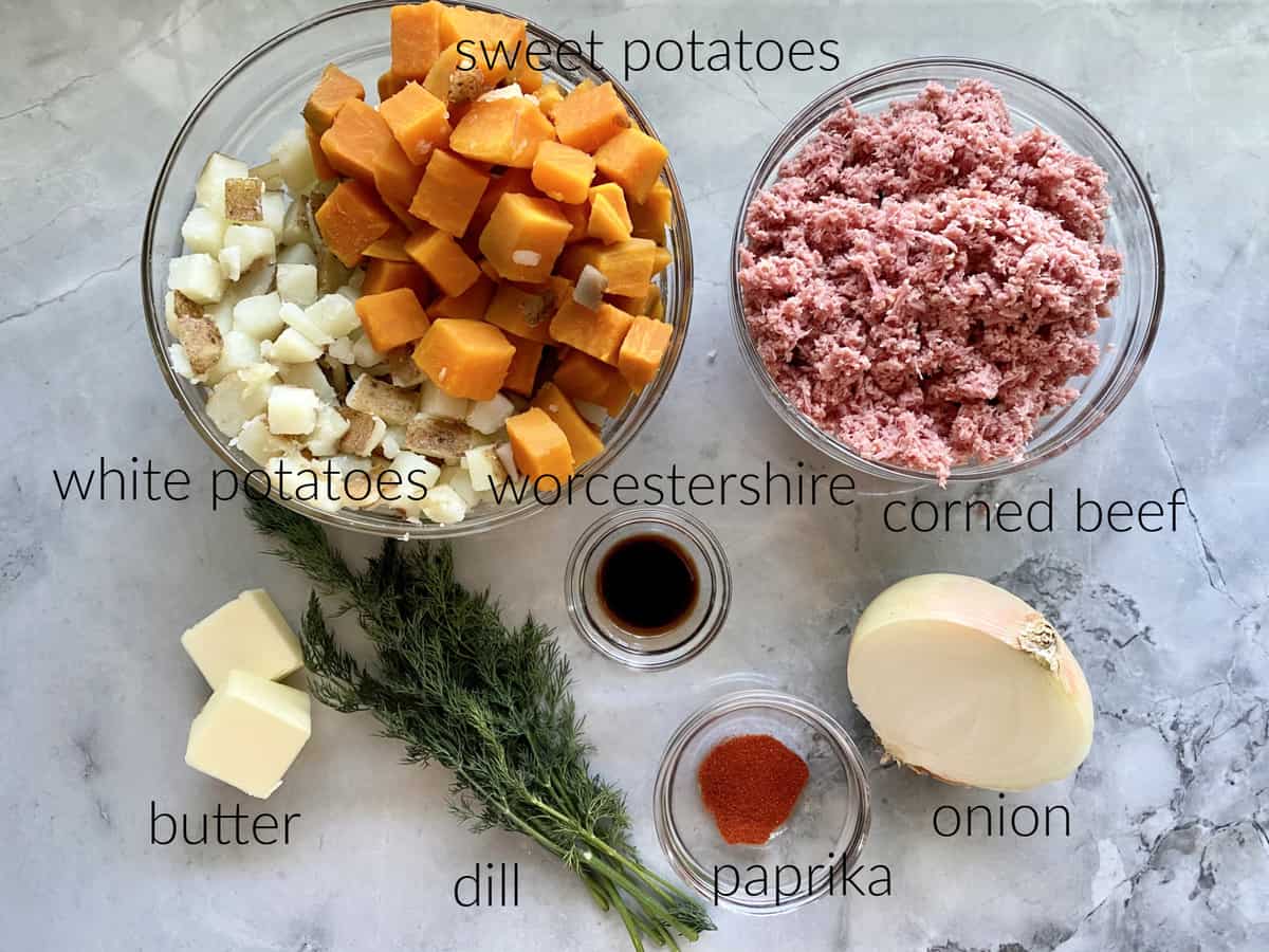 Ingredients; white potatoes, sweet potatoes, corned beef, worcestershire, butter, dill, paprika, and onion.