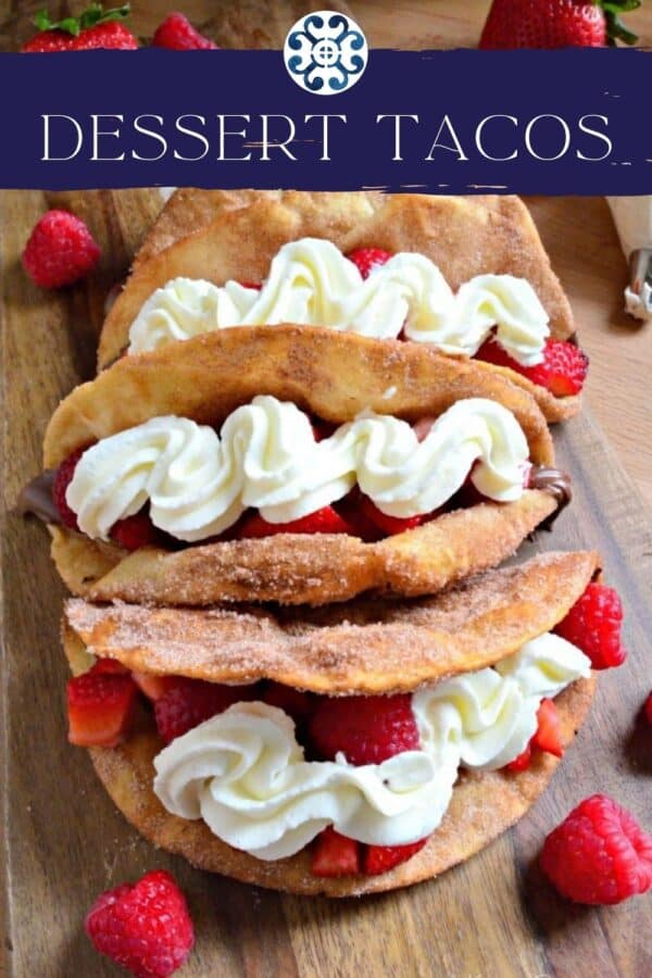 Top view of four dessert tacos topped with strawberries and whipped cream with recipe title text on image.