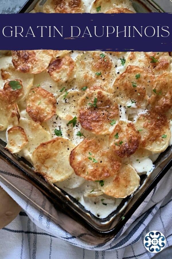 Top view of a dish of baked Gratin Dauphinois potatoes with text on image for Pinterest.