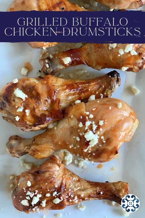 Top view of a white platter filled with Grilled Buffalo Chicken Drumsticks with text on image for pinterest.