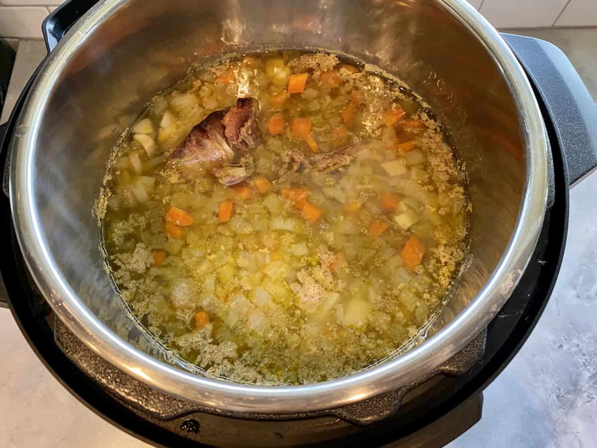 Top view of an Instant pot with cooked vegetables and meat.