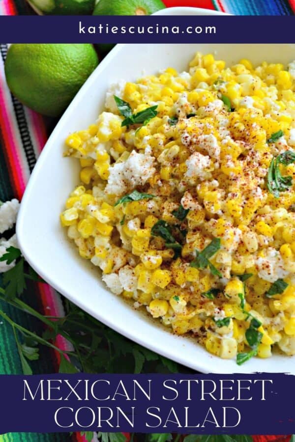 Close up of a white bowl filled with Mexican Street Corn Salad with recipe title text on image.