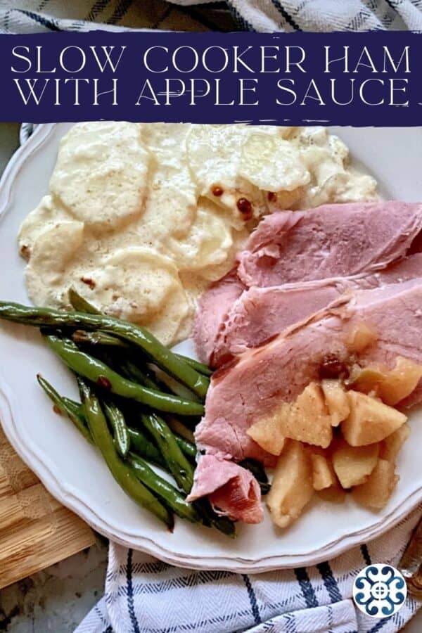 White plate filled with sliced ham, apples, potatoes, and green beans with text on image for Pinterest.