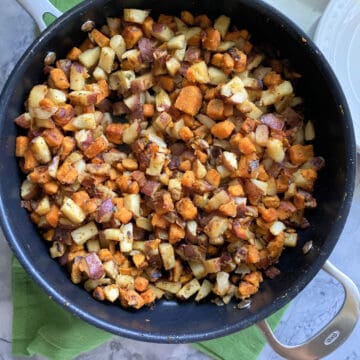 Top view of a large black skillet with Southern Breakfast Potatoes.