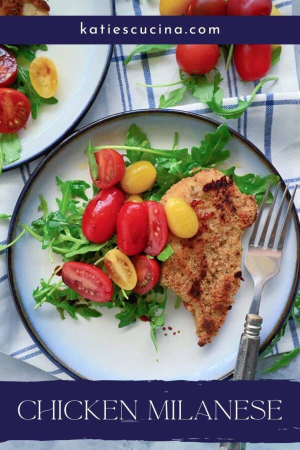 Top view of a white plate with arugula salad, chicken breast and grape tomatoes with text on image for Pitnerest.