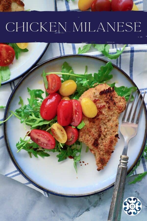 Top view of a white plate with chicken breast, salad, and tomatoes with text on image for Pinterest.