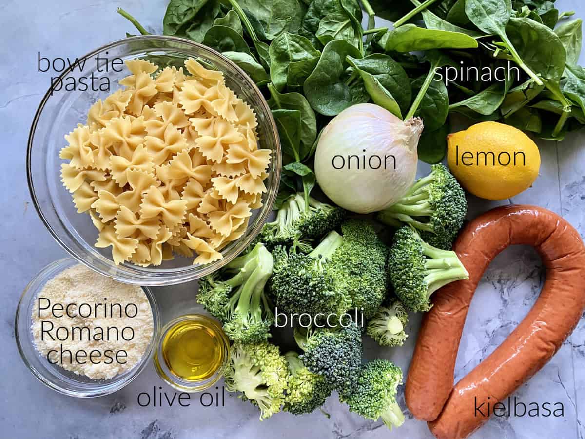 Ingredients: bow tie pasta, pecorinio romano cheese, olive oil, broccoli, onion, spinach, lemon, and kielbasa.