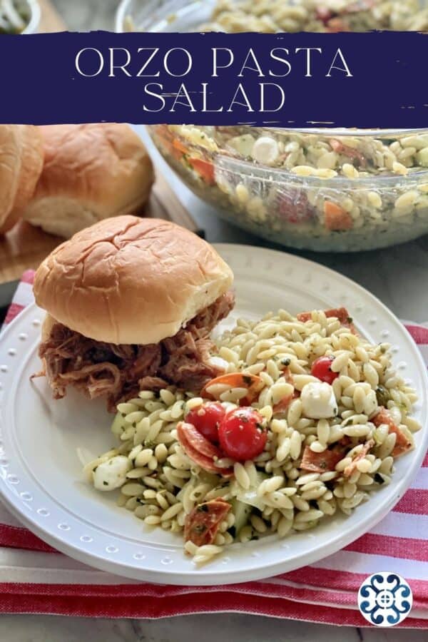 White plate filled with Orzo Pasta Salad and a pulled pork sandwich with recipe title text on image.