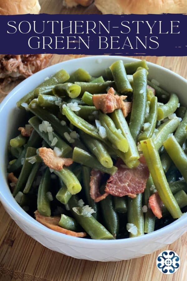 White bowl filled with cooked green beans and bacon with recipe title text on image.