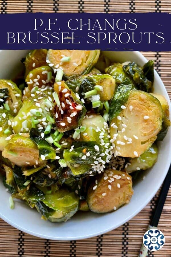 Top view of white bowl filled with sliced cooked browned brussel sprouts with recipe title text for Pinterest.