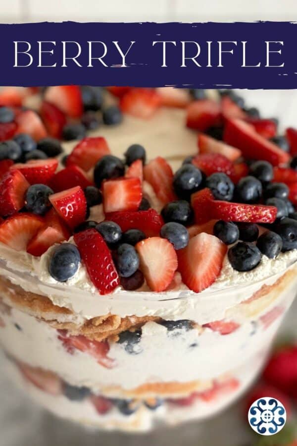 Close up of a glass Berry Trifle bowl with recipe title text on image for Pinterest.