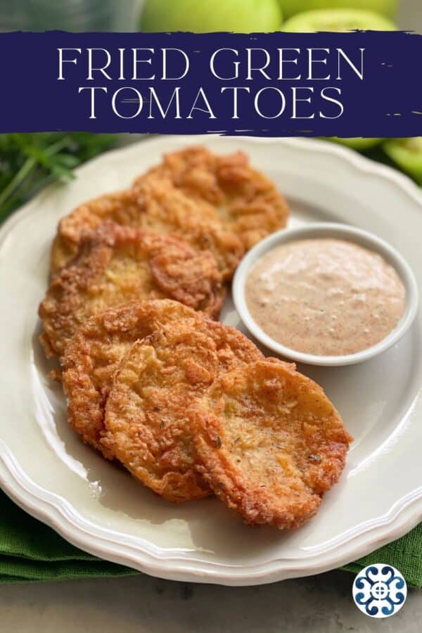 White plate filled with golden crispy green tomatoes with recipe title text on image.