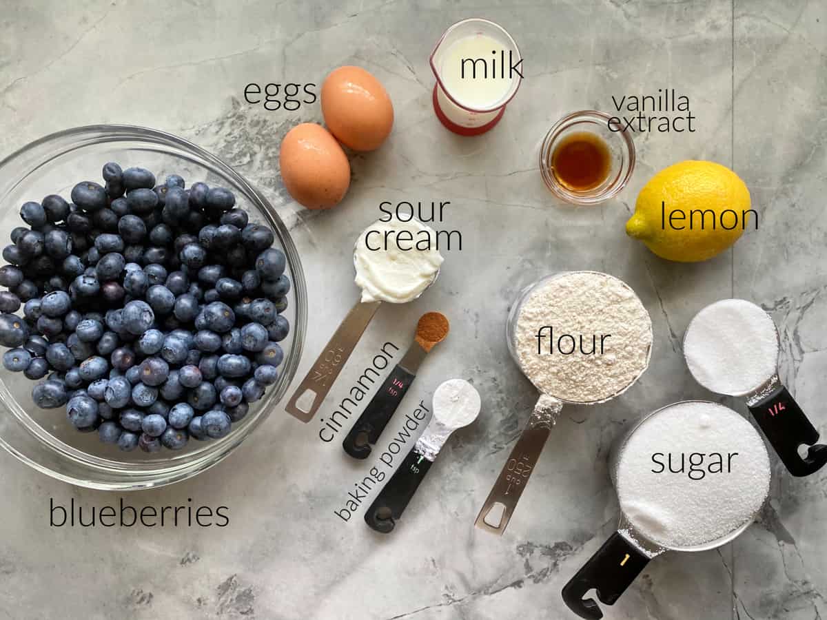 Ingredients: Blueberries, eggs, sour cream, cinnamon, baking powder, flour, sugar, lemon, vanilla extract, and milk.