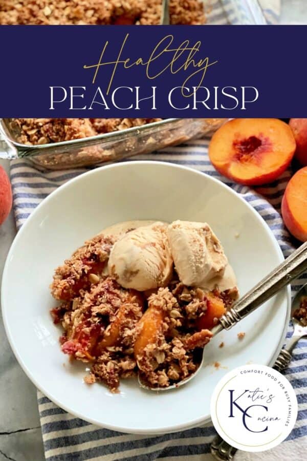 Shallow white bowl filled with ice cream, peach crisp, and a spoon with recipe title text on image for Pinterest.