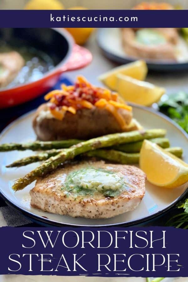 White plate filled with a swordfish steak topped with herb butter, lemon wedge, asparagus, and baked potato with text on image for Pinterest.