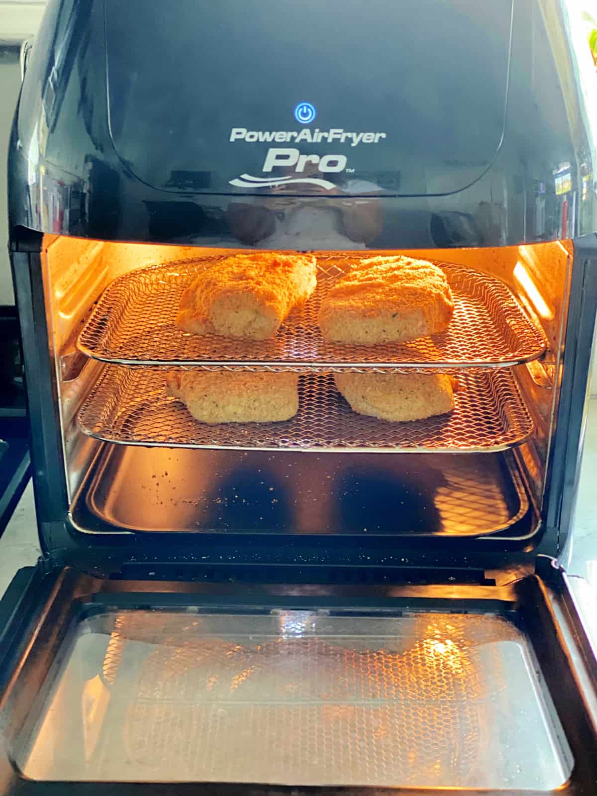 Power AirFryer Pro with two metal racks with breaded pork chops inside.