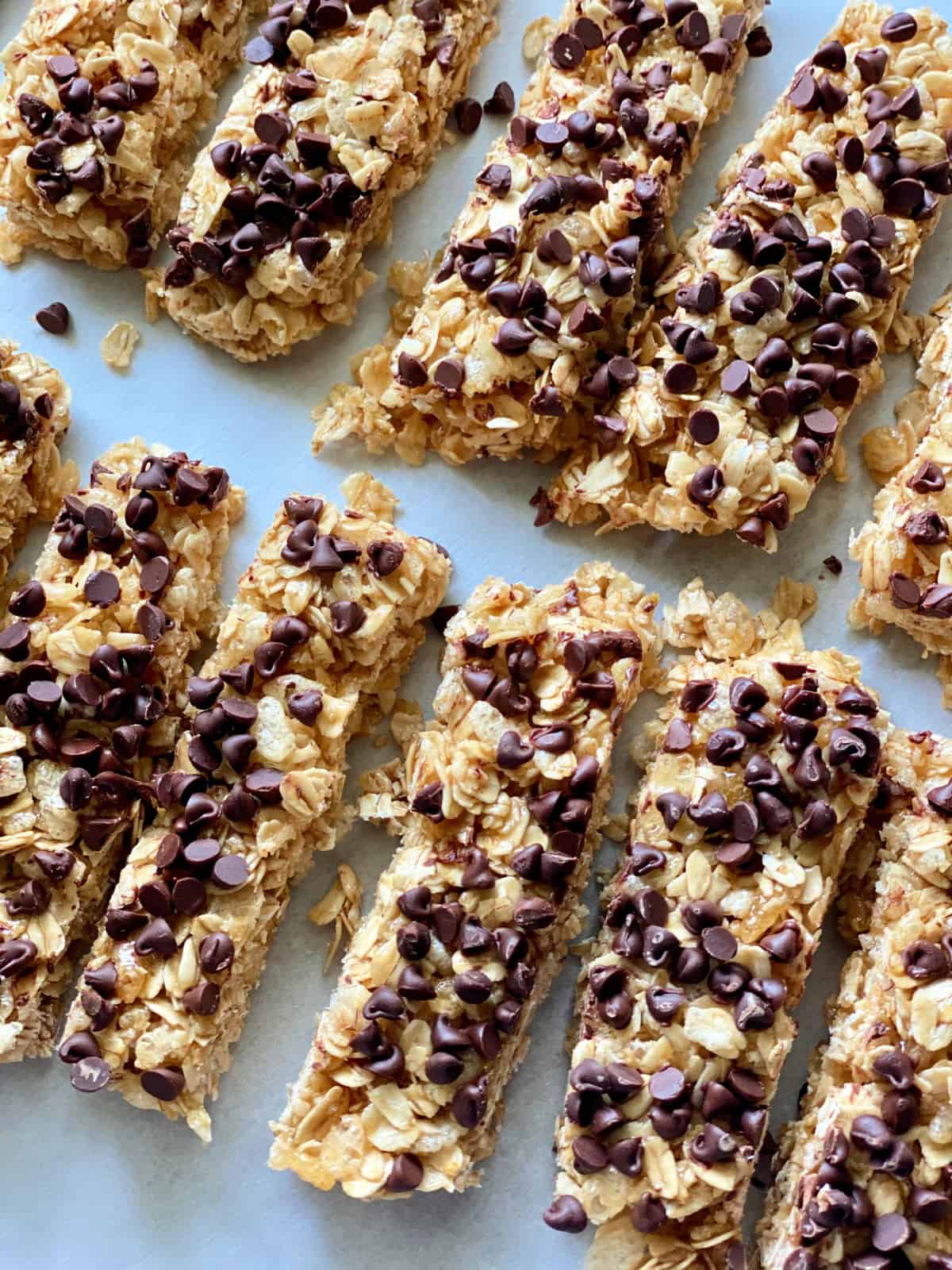 Top view of a dozen homemade granola bars with mini chocolate chips.