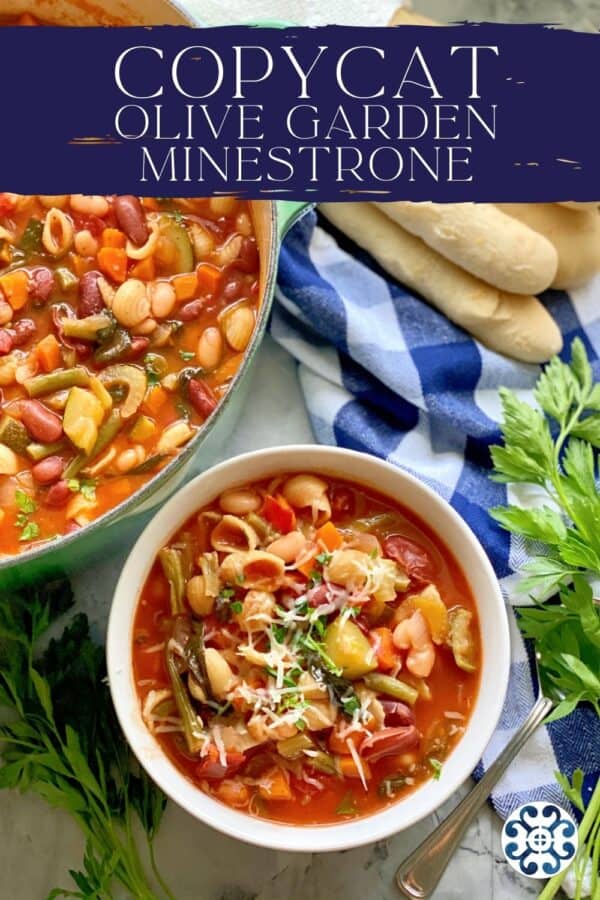 Top view of a white bowl filled with minestrone soup with a pot and breadsticks next to it with recipe title on image for Pinterest.