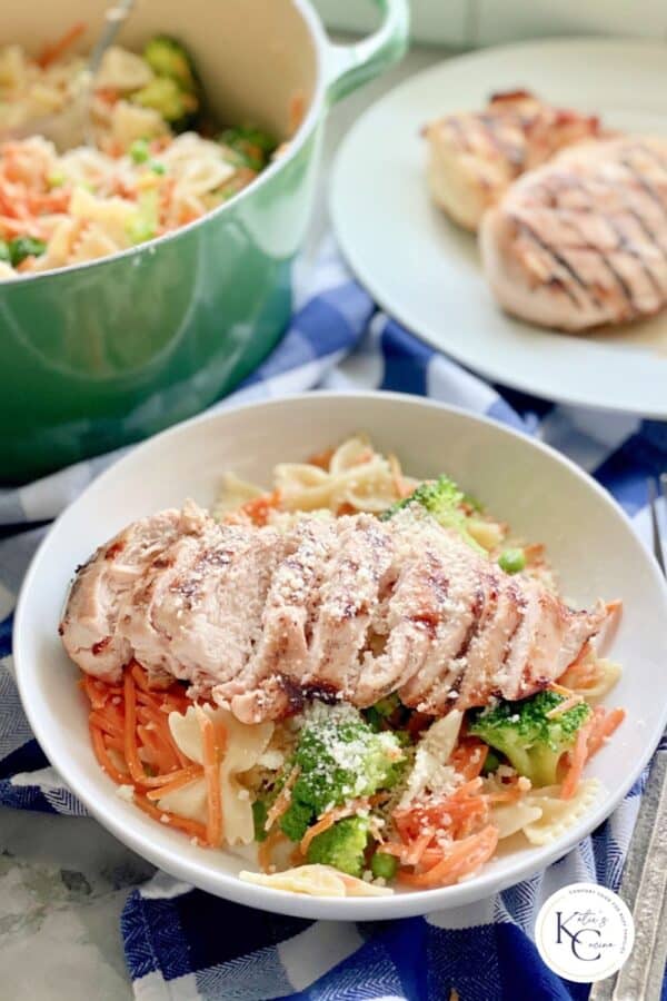 Close up of Grilled Chicken Pasta with veggies in a bowl with watermark on right bottom corner.