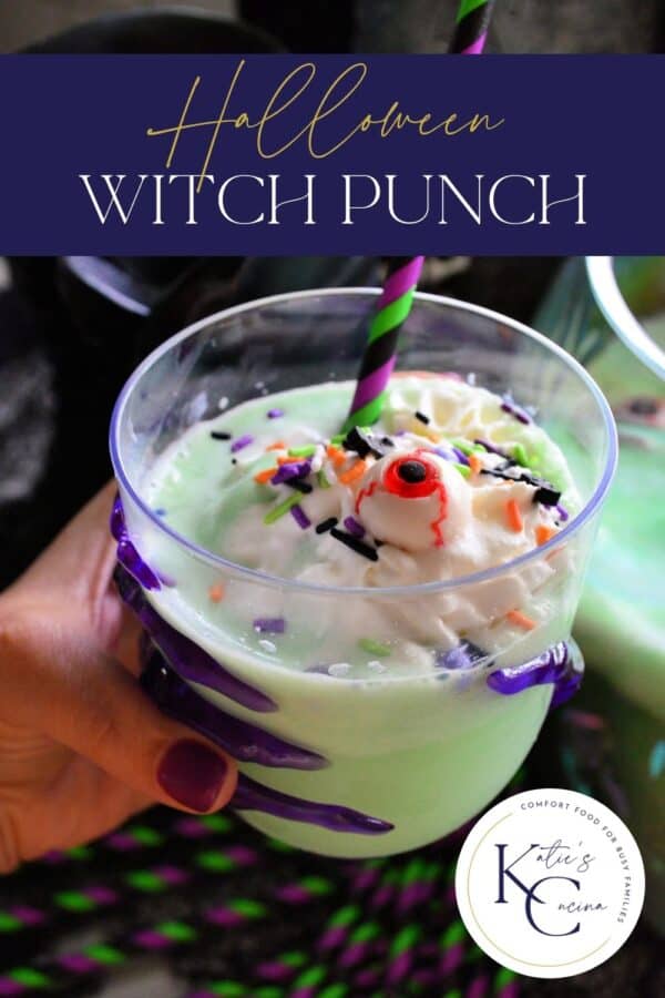 Hand with purple nails holidng a glass with a green drink with whipped cream and a striped straw with recipe title text on image for Pinterest.