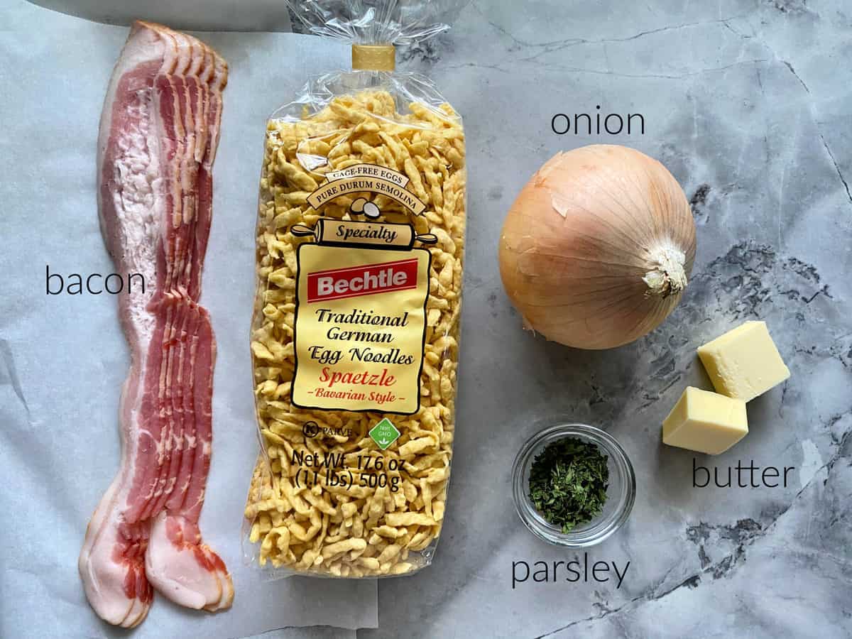 Ingredients on counter: bacon, bechtle spaetzle, onion, parsley, and butter.