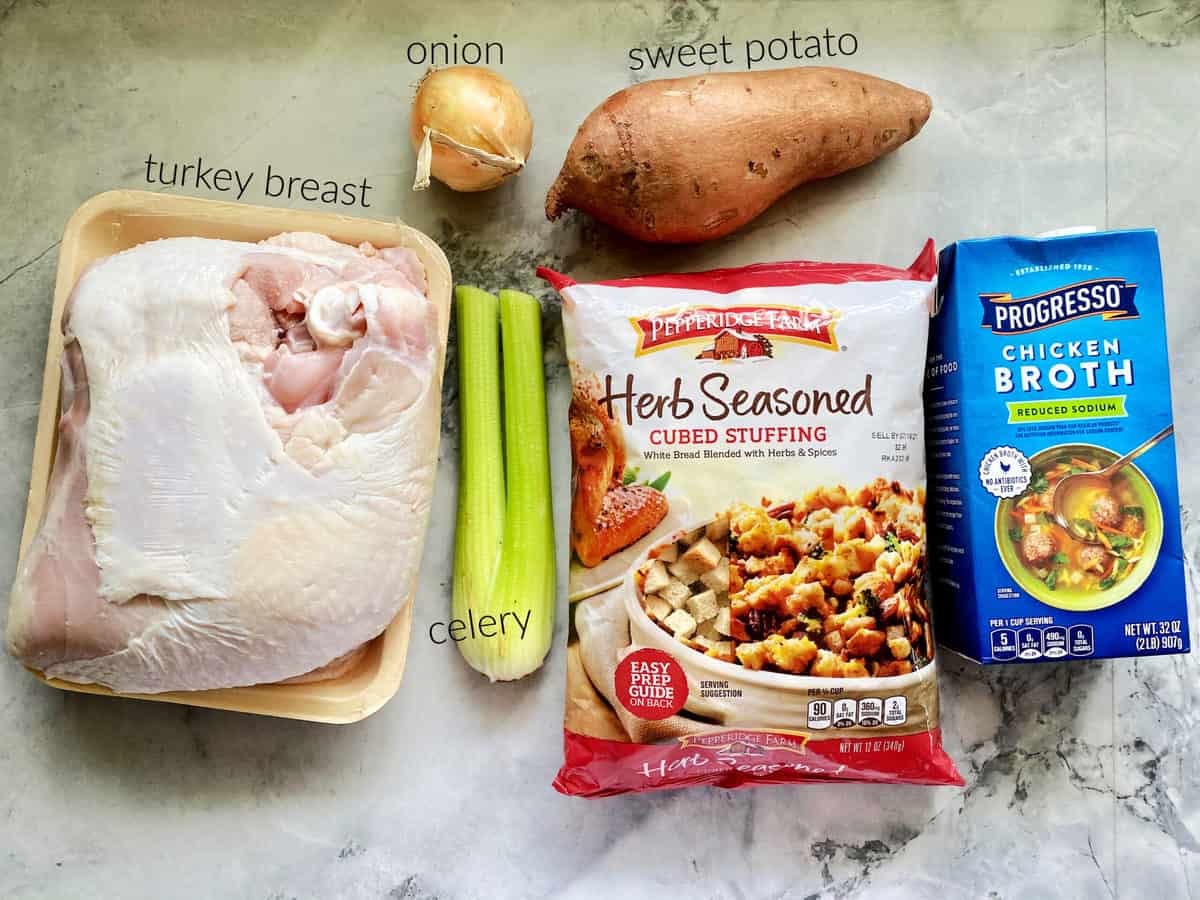 Ingredients on counter; turkey breast, onion, sweet potatoes, celery, bread stuffing, and chicken broth.