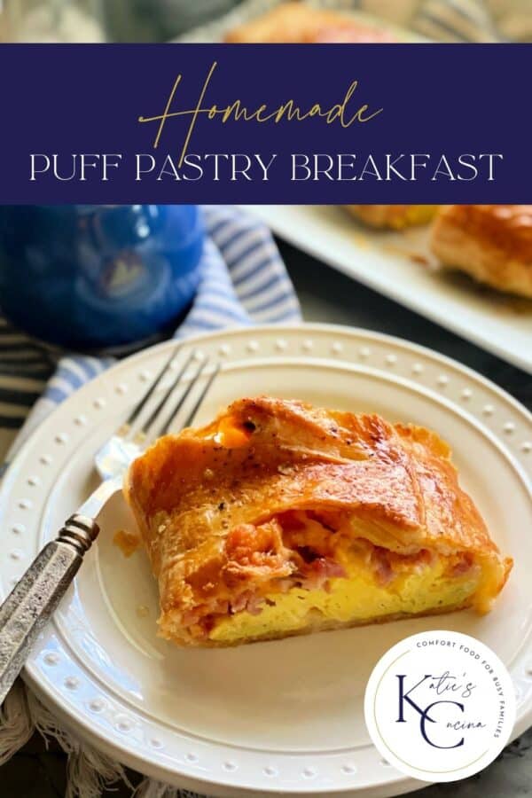 White plate filled with an egg and ham puff pastry with a fork on the plate and text on image for pinterest.