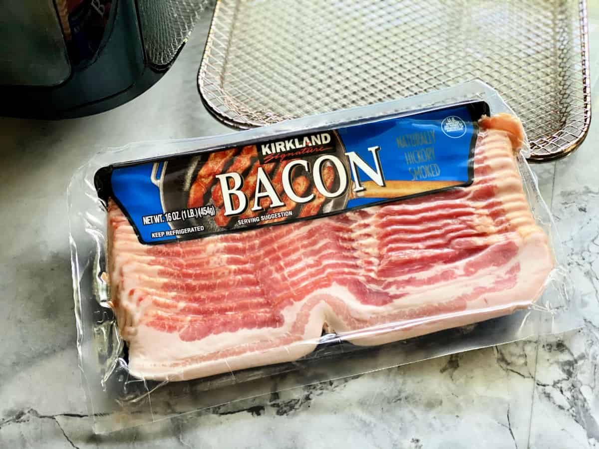 Pack of Kirkland brand bacon sitting on marble counter