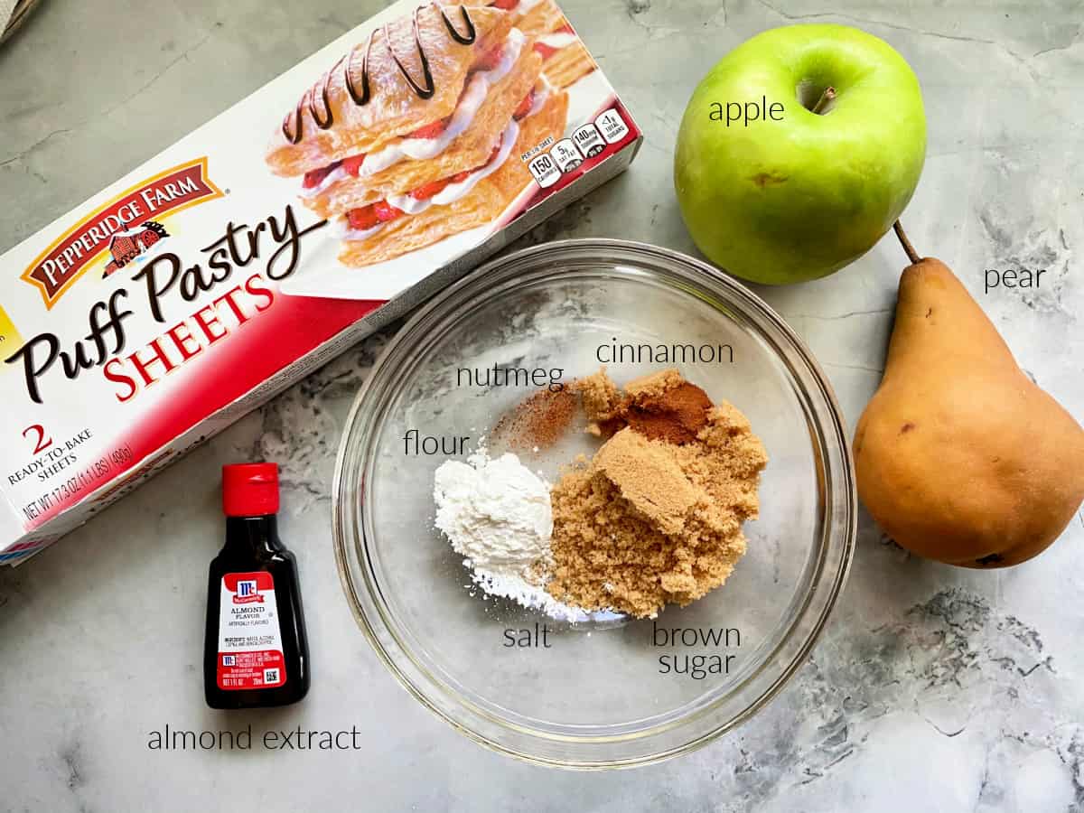 Apple & Pear Turnovers Ingredients; puff pastry, apple, pear, almond extract, brown sugar, cinnamon, nutmeg, and flour.