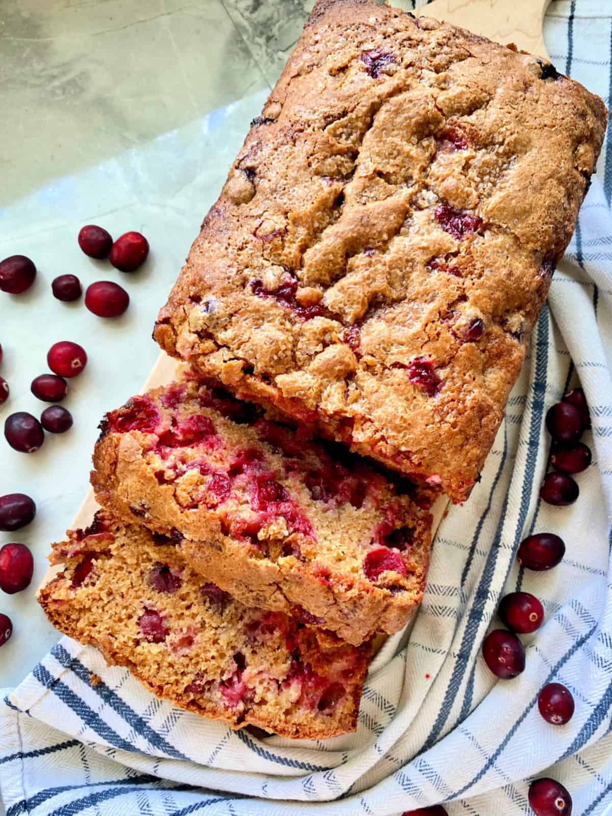 Top view of Cranberry Bread with two slices from loaf. 