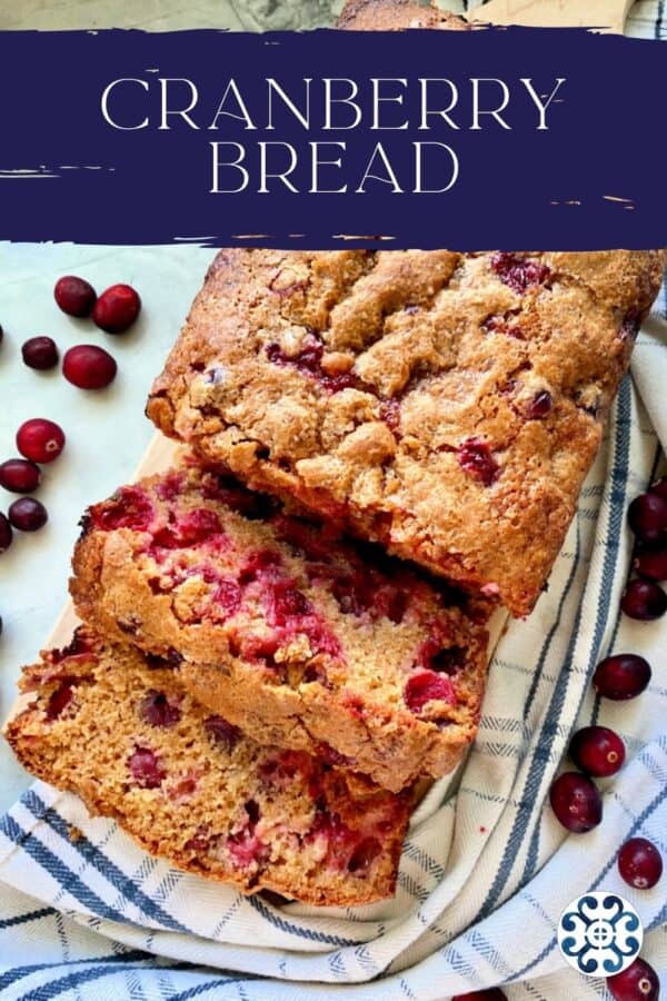 Top view of Cranberry Bread sliced on a cutting board with text on image for Pinterest.