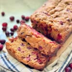 square photo of Cranberry Bread sliced on a cloth.