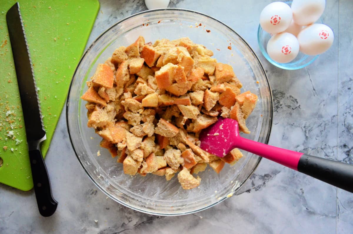 Top view of French toast muffin stuffing mixed in bowl with spatula