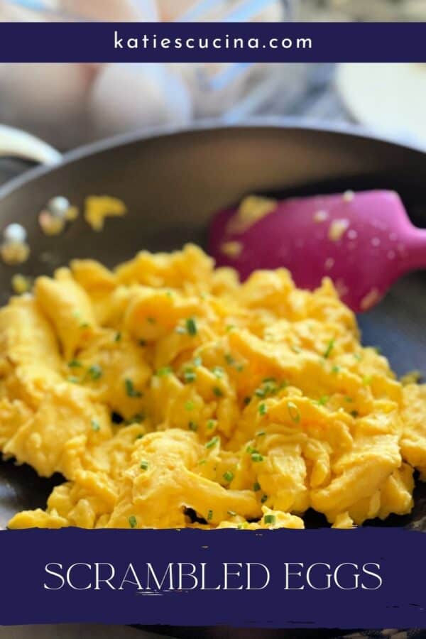 Frying pan with scrambled eggs and pink spatula with recipe title text on image.