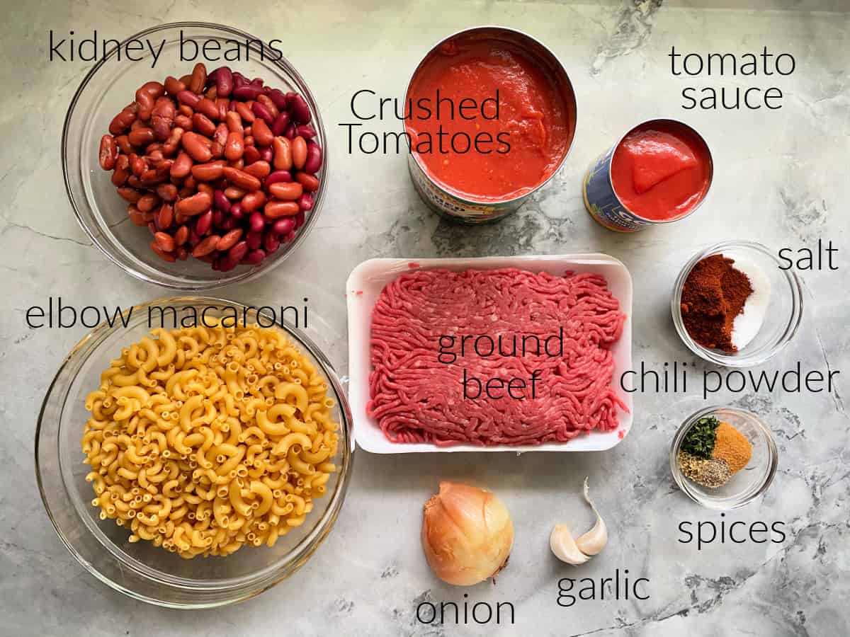 Ingredients: elbow macaroni, kidney beans, crushed tomatoes, ground beef, onion, garlic, spices, chili powder & salt, and tomato sauce
