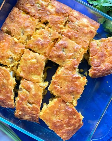 top view shot of thirteen slices of cornbread in square glass baking dish