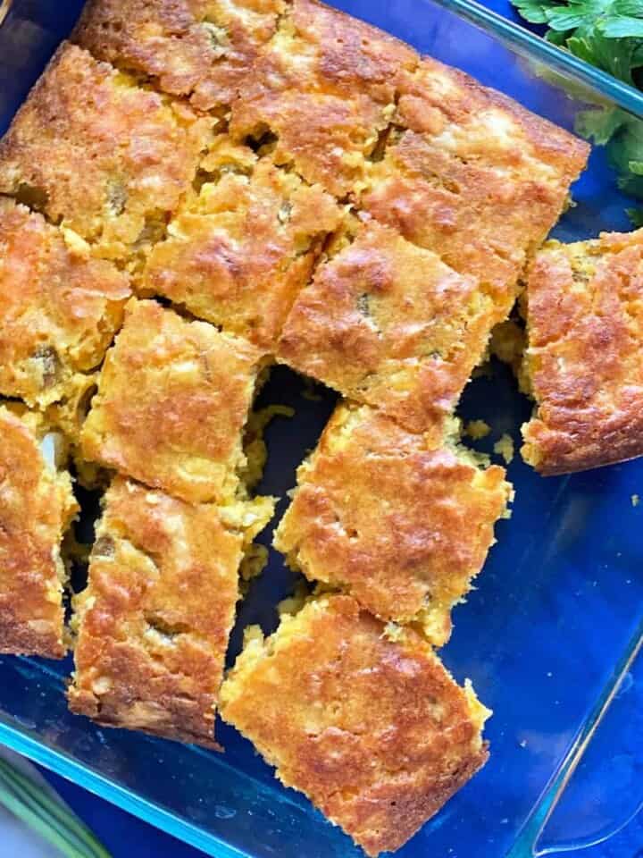 top view shot of thirteen slices of cornbread in square glass baking dish