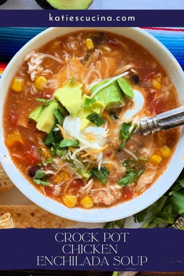 Chicken enchilada soup in white bowl with spoon, title text below