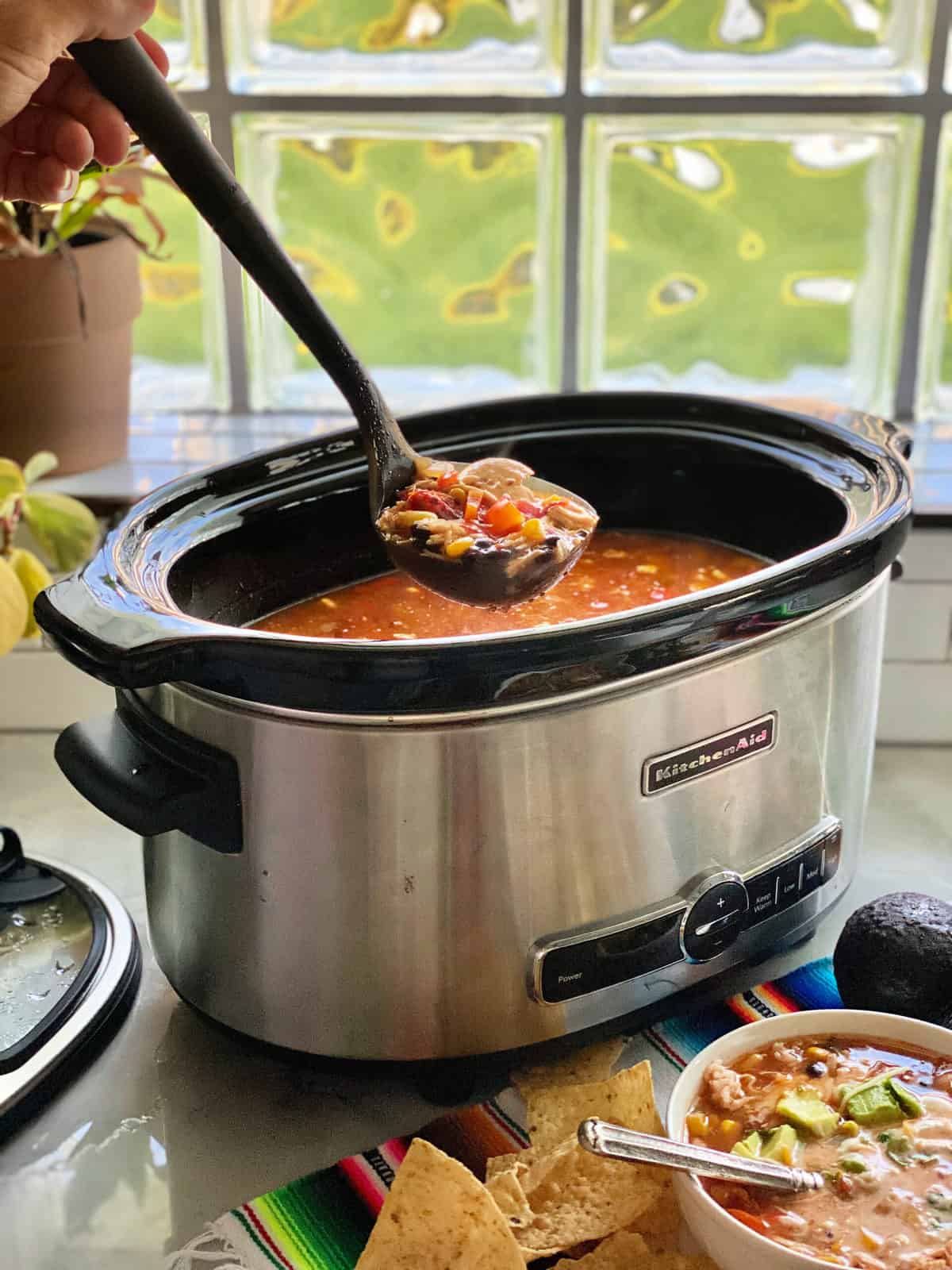 Chicken enchilada soup ladled out of crock pot