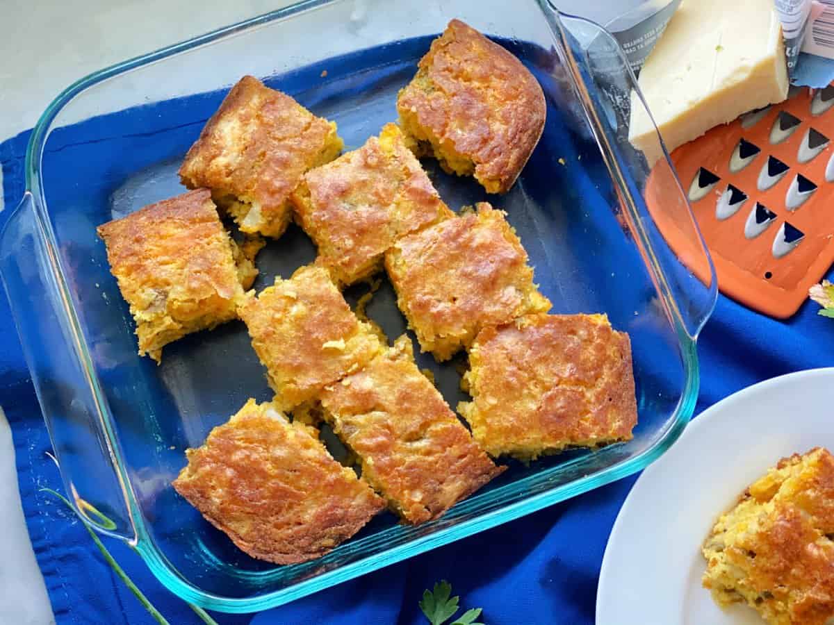 nine slices of cornbread in square glass baking dish