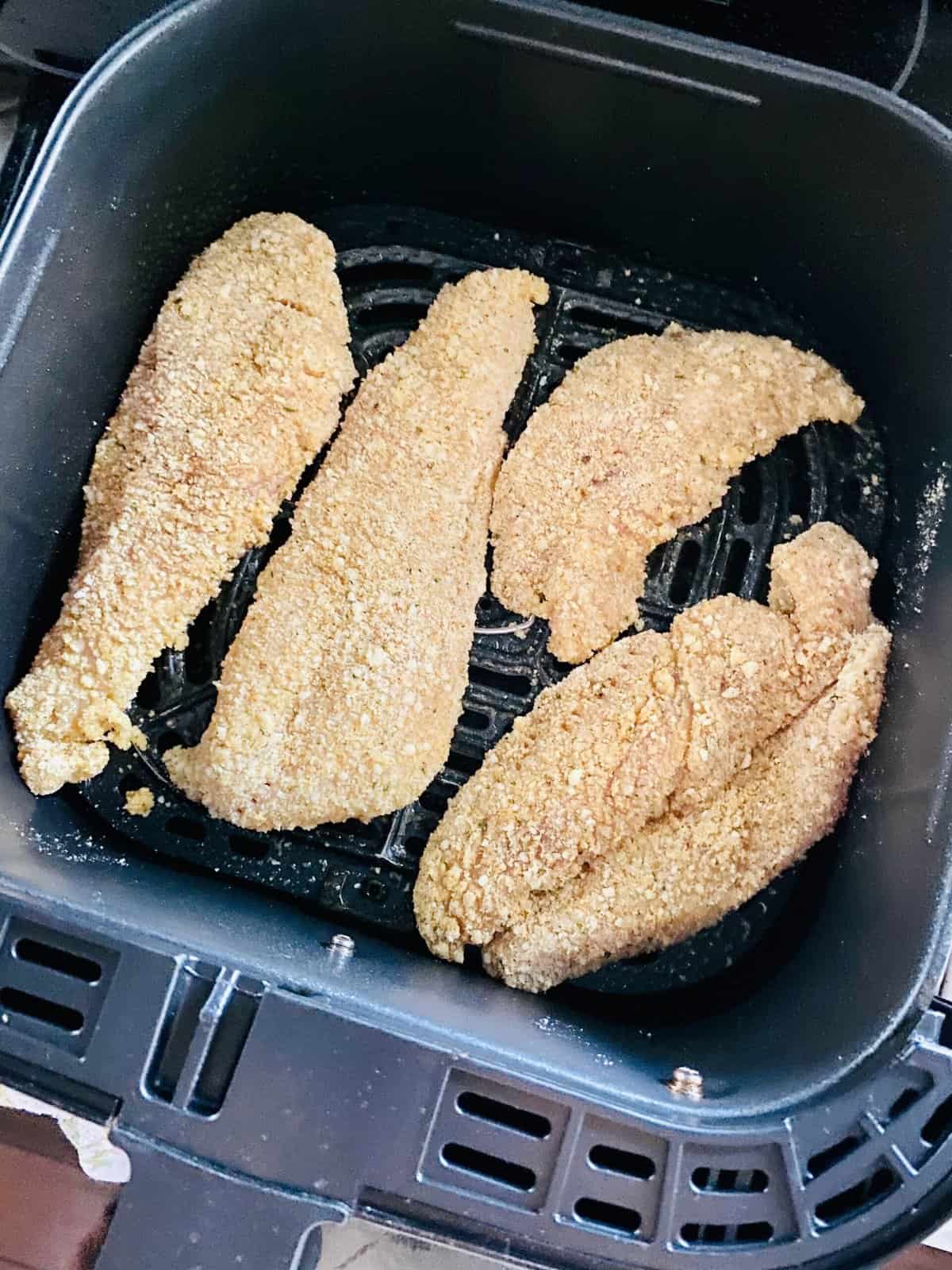 Breaded chicken cutlets in air fryer basket