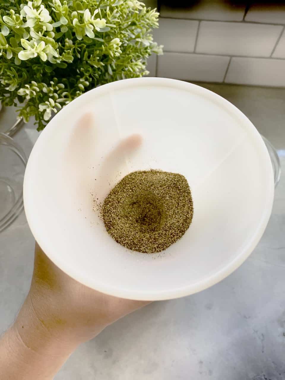 Spices going through a funnel into container