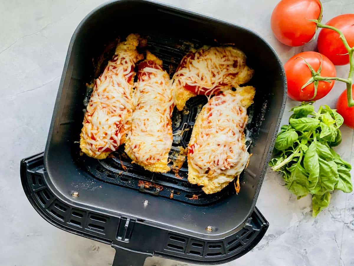 Top view shot of finished chicken parmesan in air fryer basket