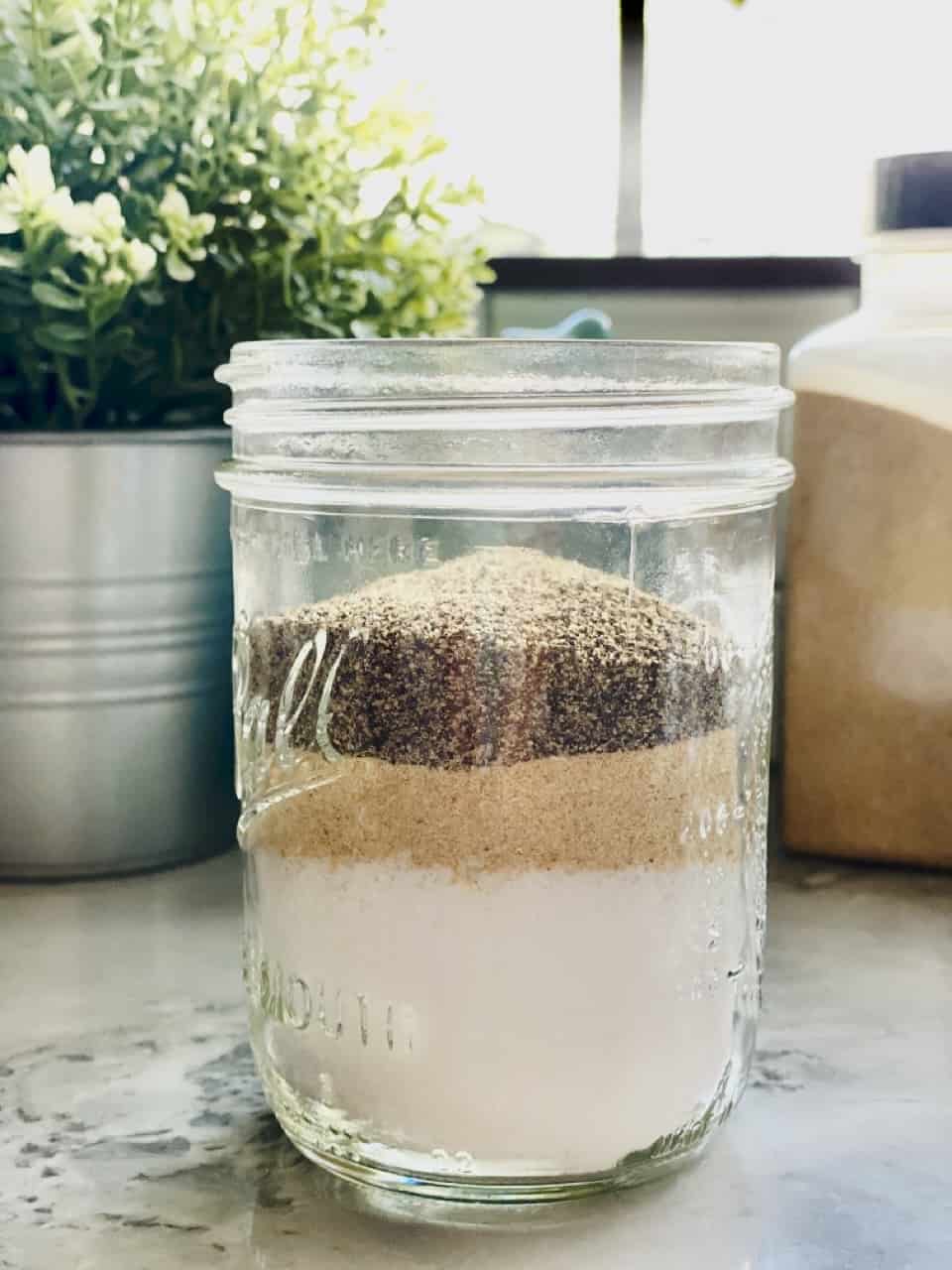 House seasoning ingredients layered in glass jar