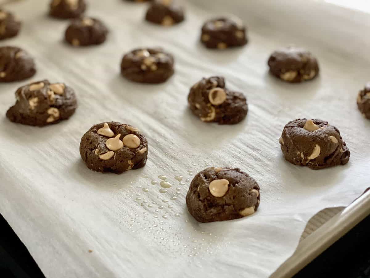 15 Chocolate peanut butter cookie dough rounds on baking sheet