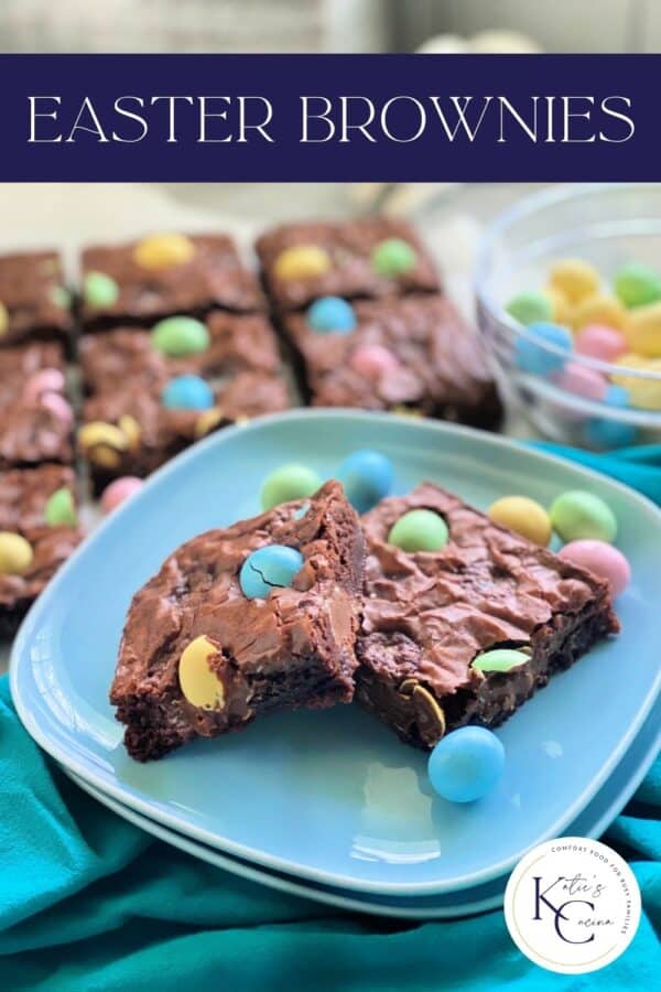 Two square blue plates stacked with 2 brownies with egg candies and recipe title text on image for Pinterest.