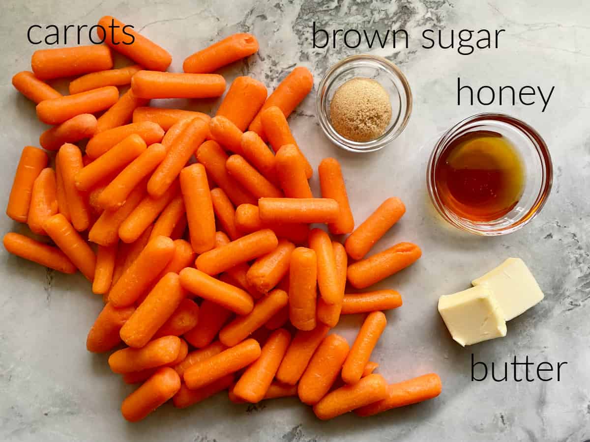 ingredients on counter; carrots, brown sugar, honey, and butter.
