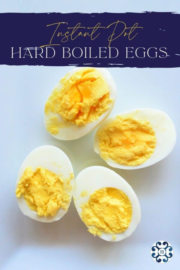 Close up of two hard boiled eggs cut open with recipe title text on image for Pinterest.