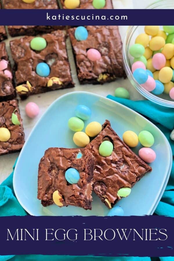 Top view of two blue square plates with 2 brownies with hard shell eggs and recipe title text on image for Pinterest.
