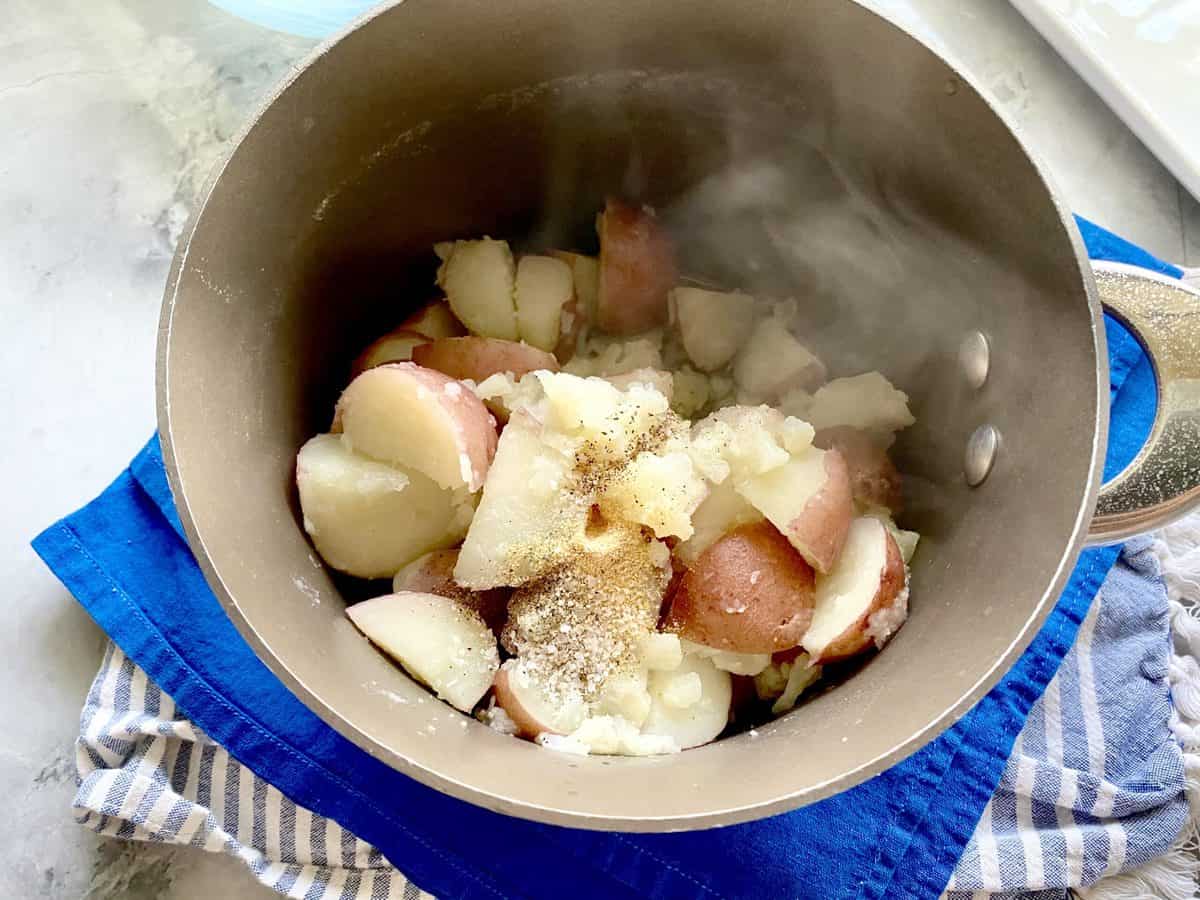 Drained boiled potatoes in a pot